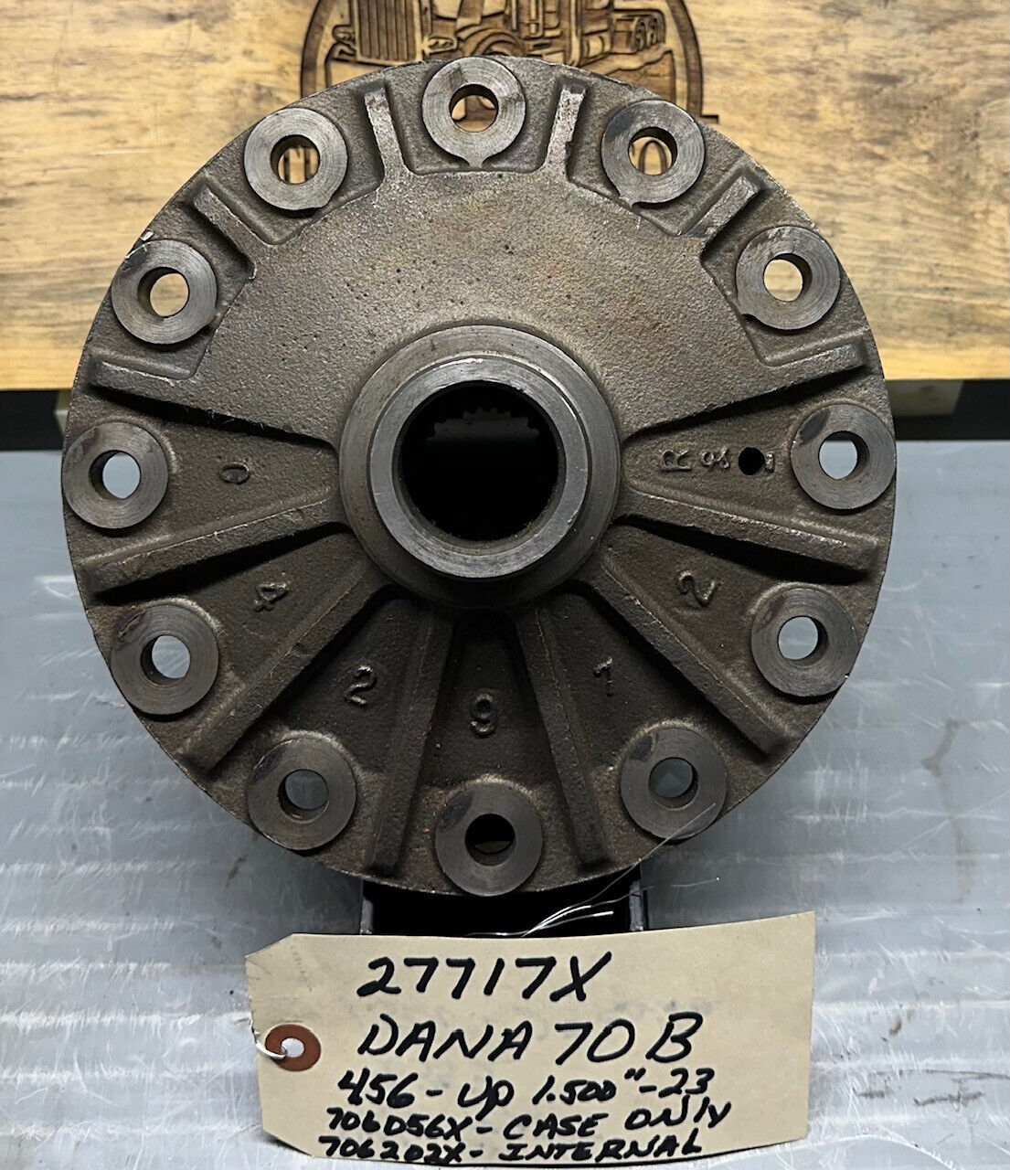 Back face of Dana Spicer 27717-X differential case showing ring-gear mounting flange and bolt holes — Dana 70-B, New OE, standard case (not Power Lok), fits 4.56 and higher ratios