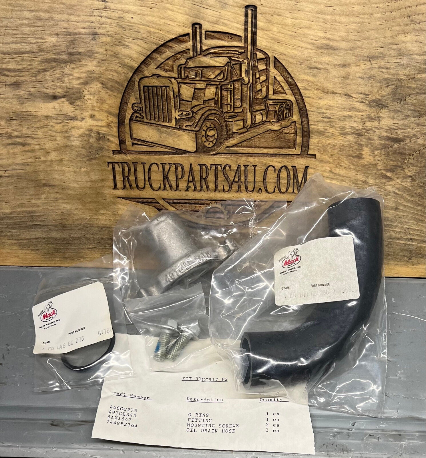 Close-up of full 57GC517P2 Mack oil drain kit – all OEM components laid out