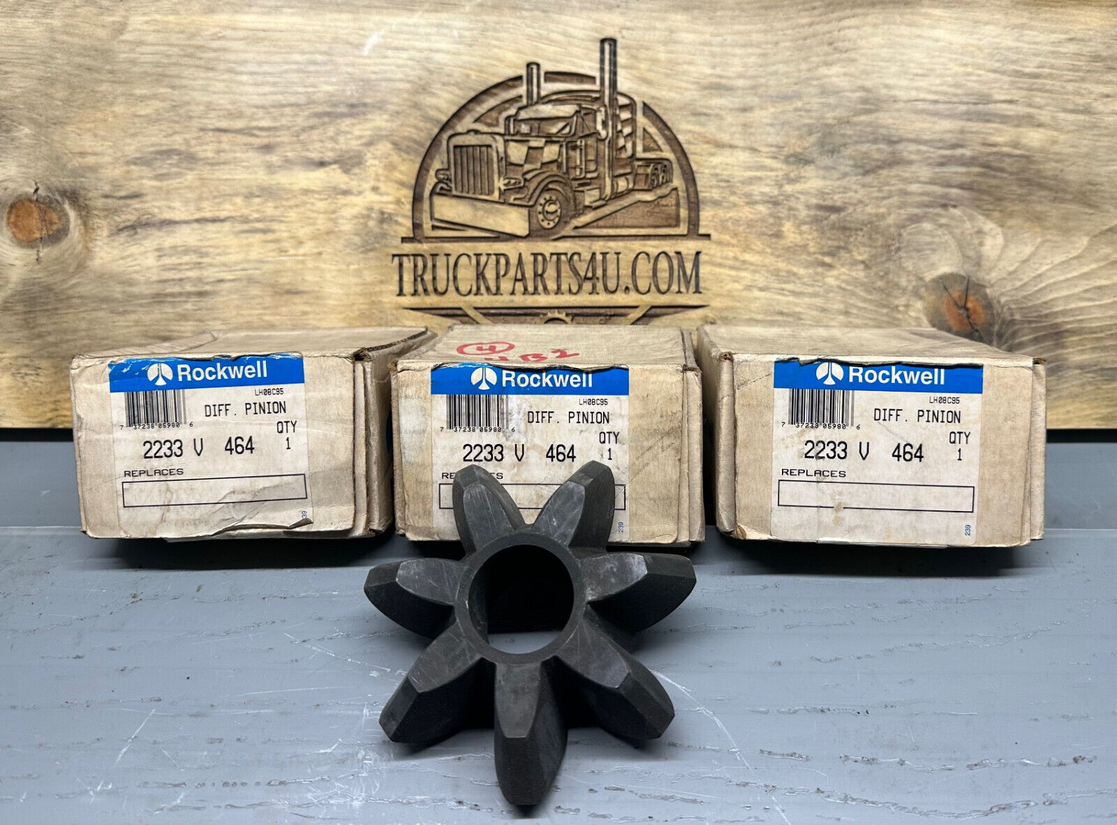 2233V464 Meritor-Rockwell-AxleTech differential pinion gear – new genuine OEM shown with original Rockwell boxes on TruckParts4U.com burnt board