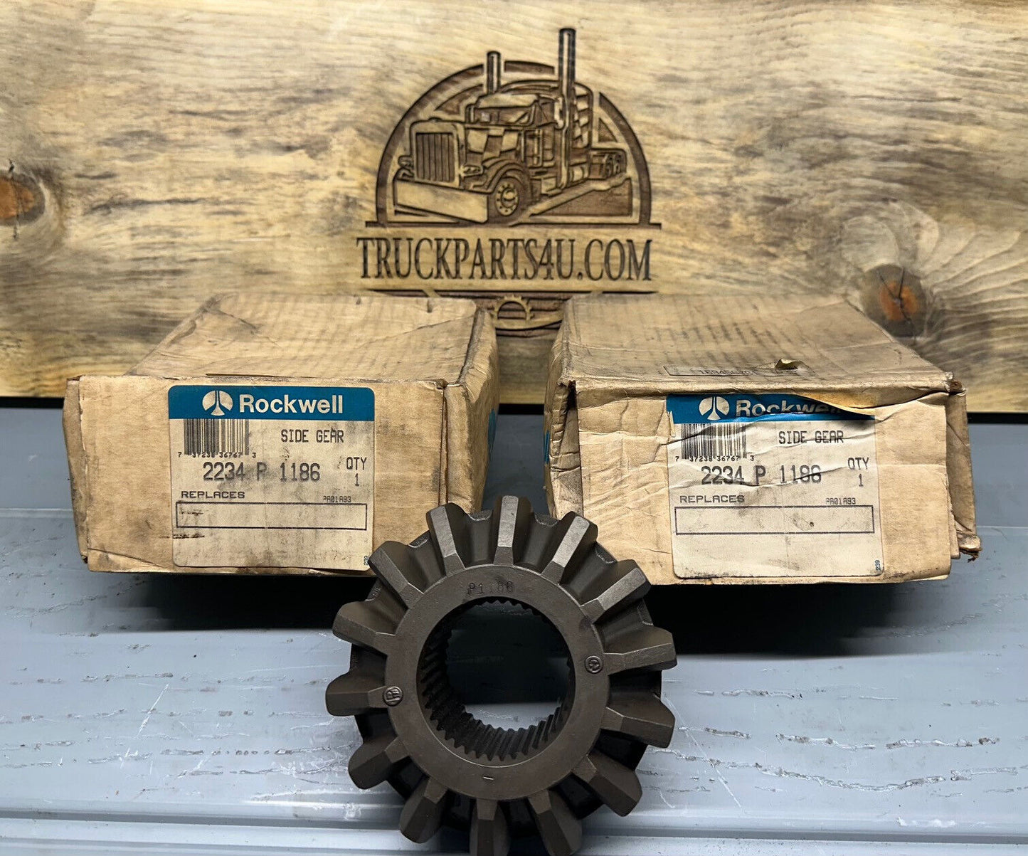 2234P1186 Meritor-Rockwell-AxleTech side gear – new genuine OEM shown with original Rockwell boxes on TruckParts4U.com burnt board