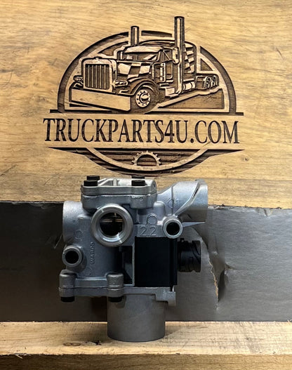 Front view of Meritor WABCO 400-611-002-0 ABS modulator valve for heavy-duty truck air brake systems, shown against TruckParts4U.com branded wood background.