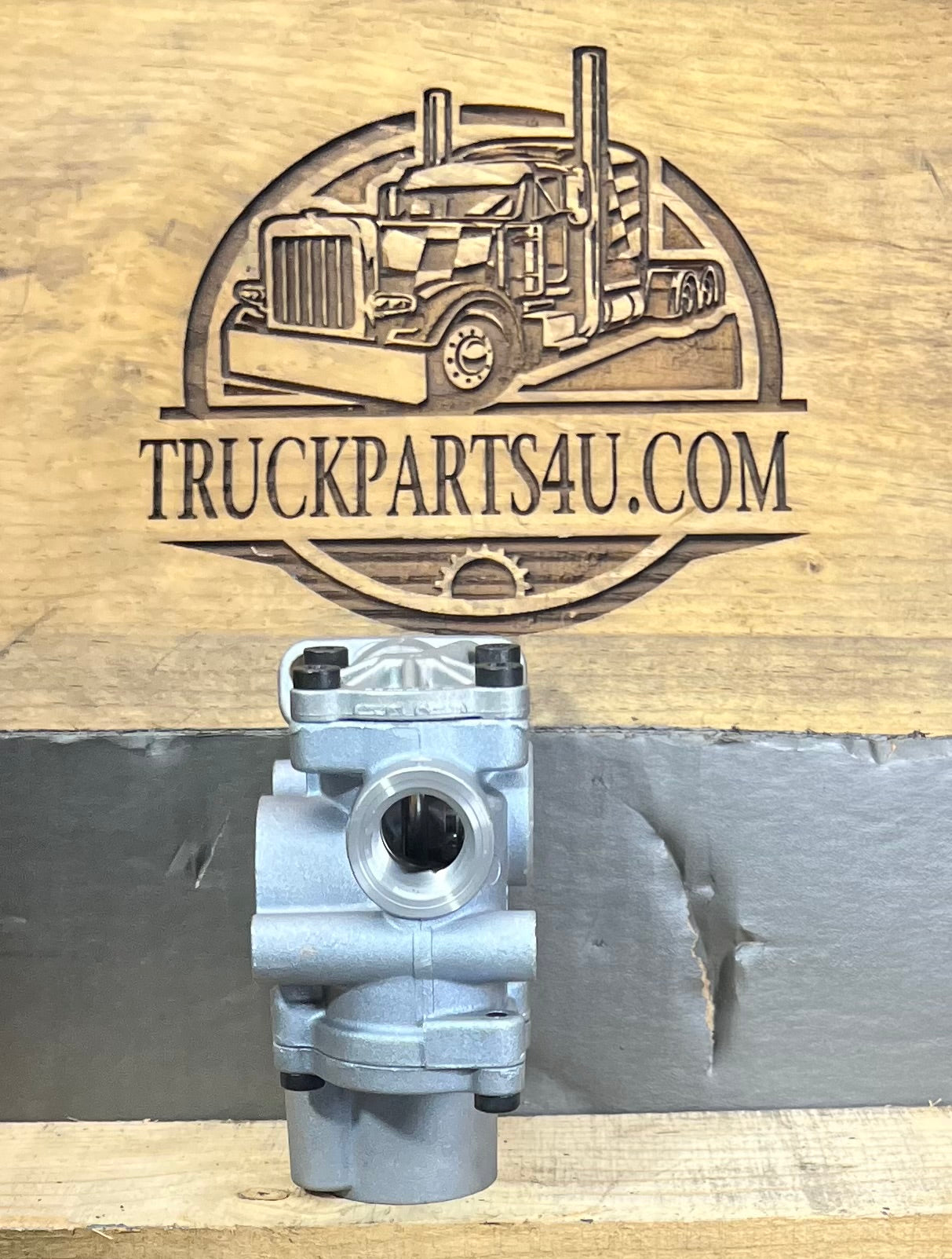 Port-side view of Meritor WABCO 400 611 002 0 ABS modulator valve for heavy-duty truck air brake systems, shown against TruckParts4U.com branded wood background.