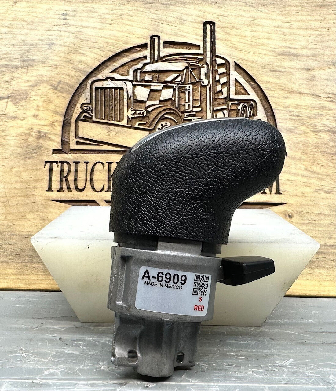 A6909 Eaton Fuller Roadranger pistol-grip shift knob and valve assembly showing black ergonomic grip and valve body with A-6909 label – new genuine OEM