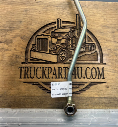 Close-up of Bobcat steel tube assembly label showing OEM part number 6535425 and manufacturing date