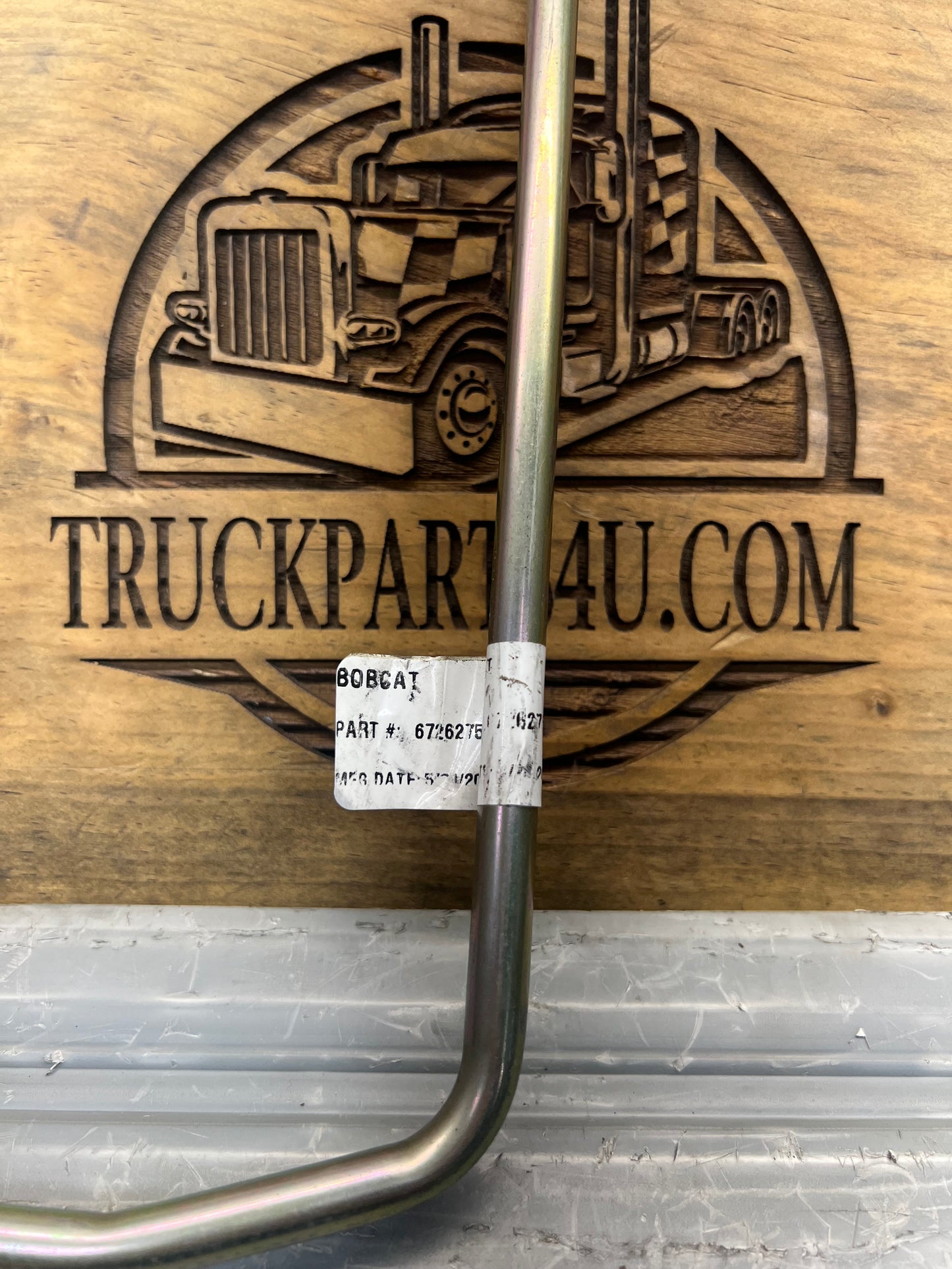 Close-up of Bobcat hydraulic tube assembly label showing OEM part number 6726275