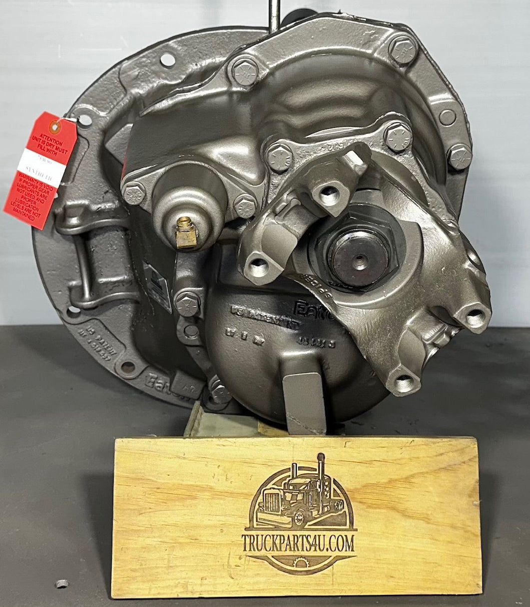 Front view of DS402 Eaton Dana-Spicer front differential remanufactured by DPX on branded wooden display block