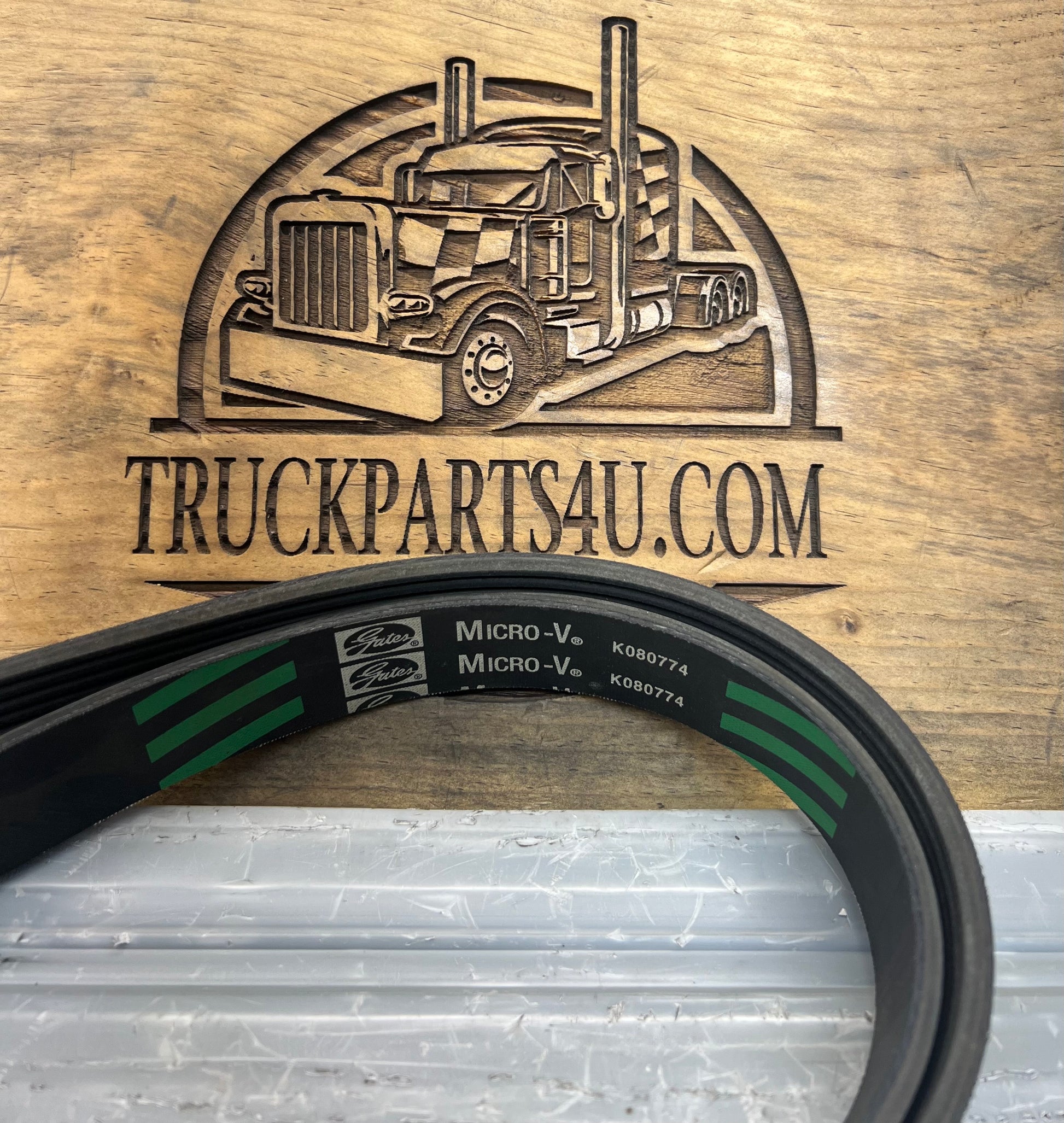Close-up of Gates Micro-V Green Stripe serpentine belt showing K080774 part number and belt branding