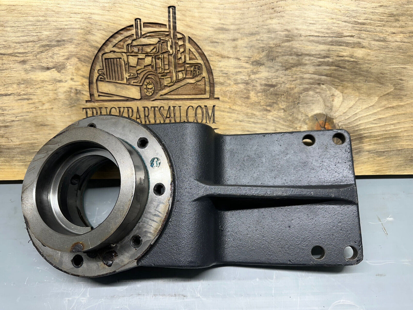 Meritor 3226G1203 / casting number 3226F1202 carrier mount for heavy-duty Meritor, Rockwell F106 axle.  Top view showing flange bolt pattern and machined bearing hub (new genuine).