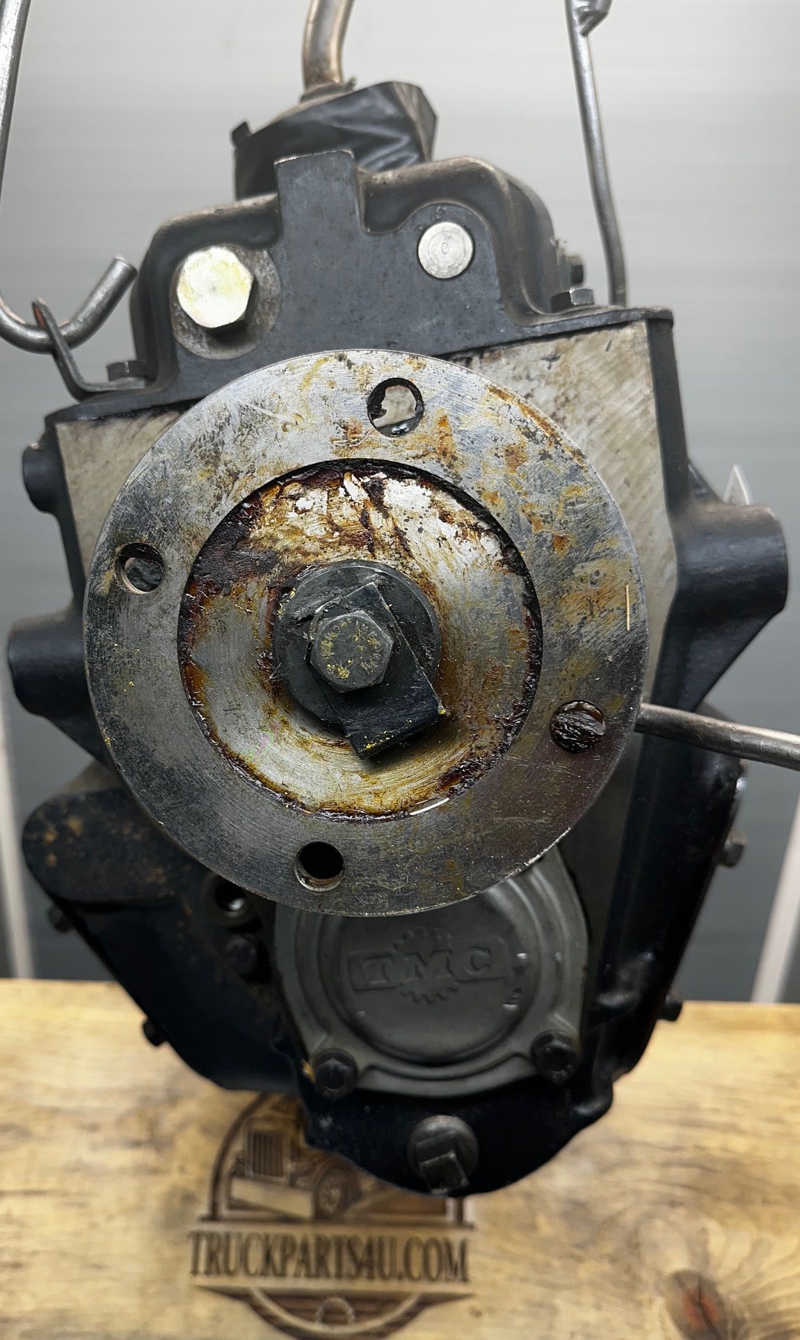 Detailed close-up of rear output shaft and output flange on NOS Turner-Spicer T5A-3278 transmission, showing splined output shaft, driveline flange TMC casting mark visible, on the countershaft bearing cover