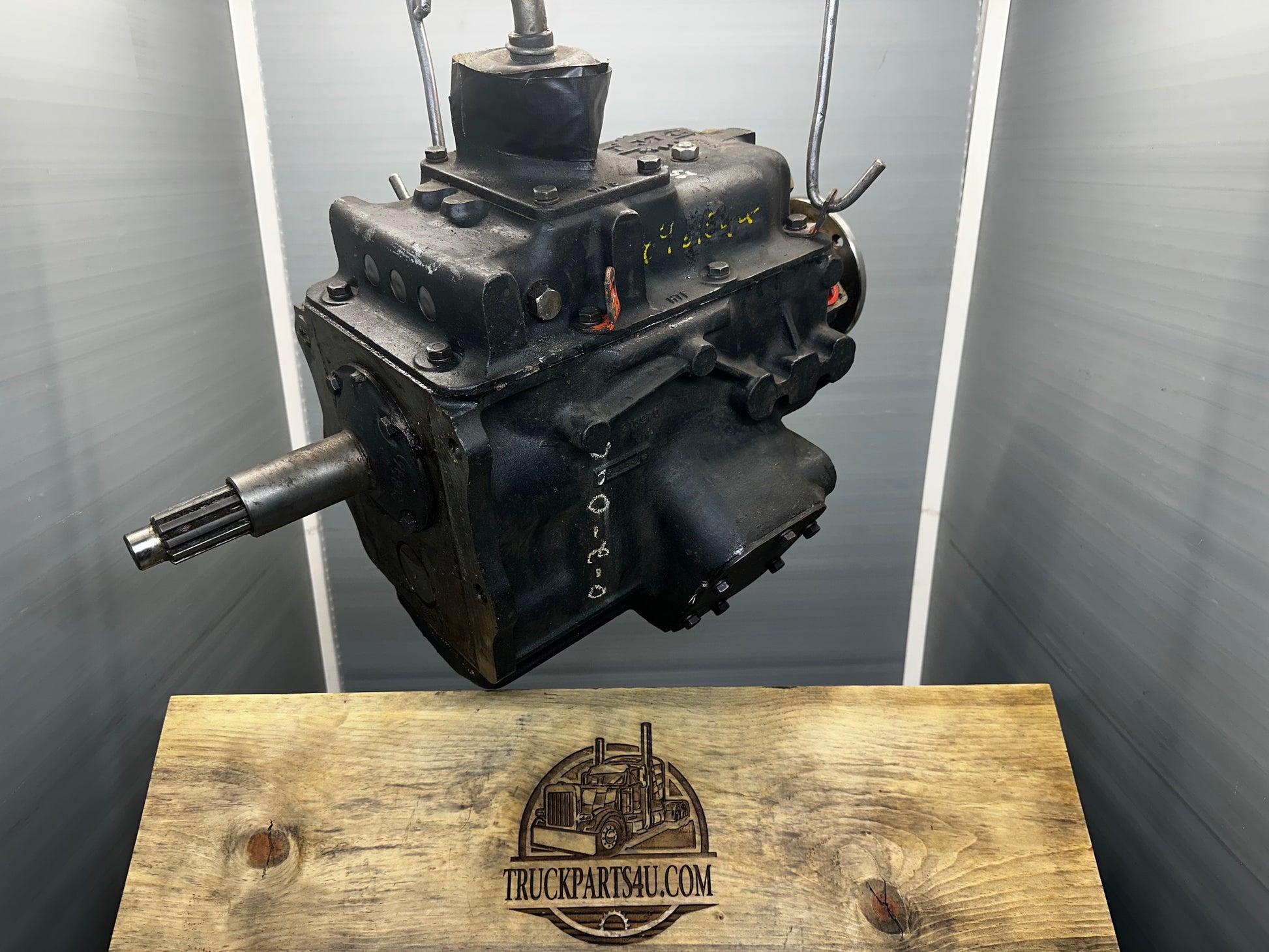 Full side profile of pristine surplus Turner-Spicer T5A-3278 T5A-300 series 5-speed overdrive transmission, highlighting factory data plate, PTO cover plate, splined output shaft, and overall factory-fresh black paint condition