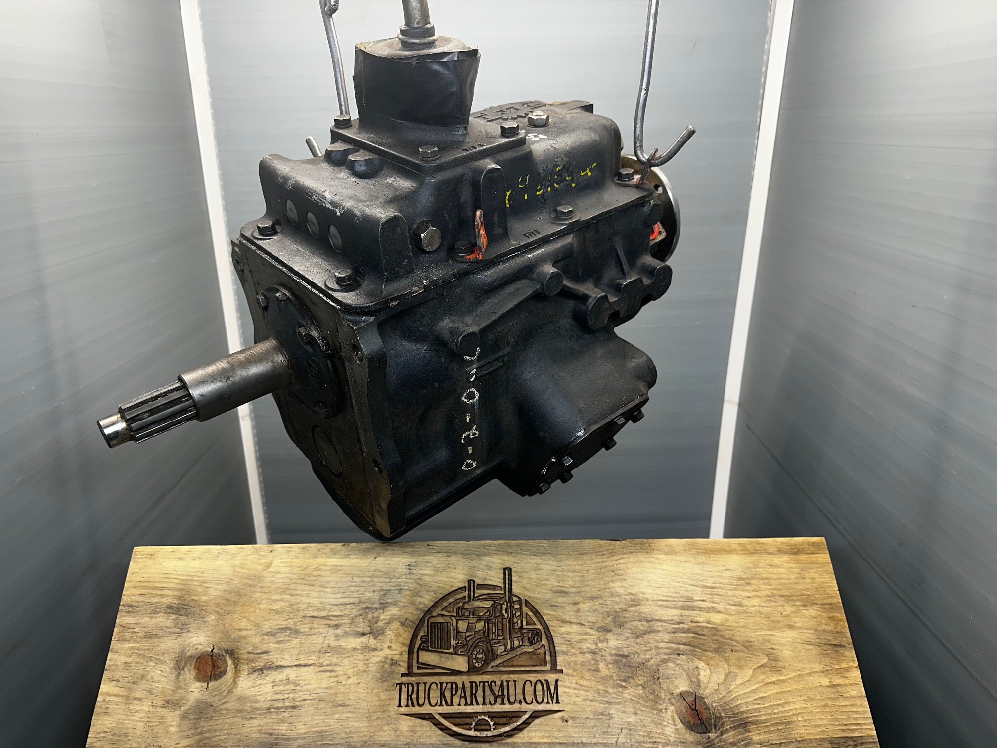 Full side profile of pristine surplus Turner-Spicer T5A-3278 T5A-300 series 5-speed overdrive transmission, highlighting factory data plate, PTO cover plate, splined output shaft, and overall factory-fresh black paint condition