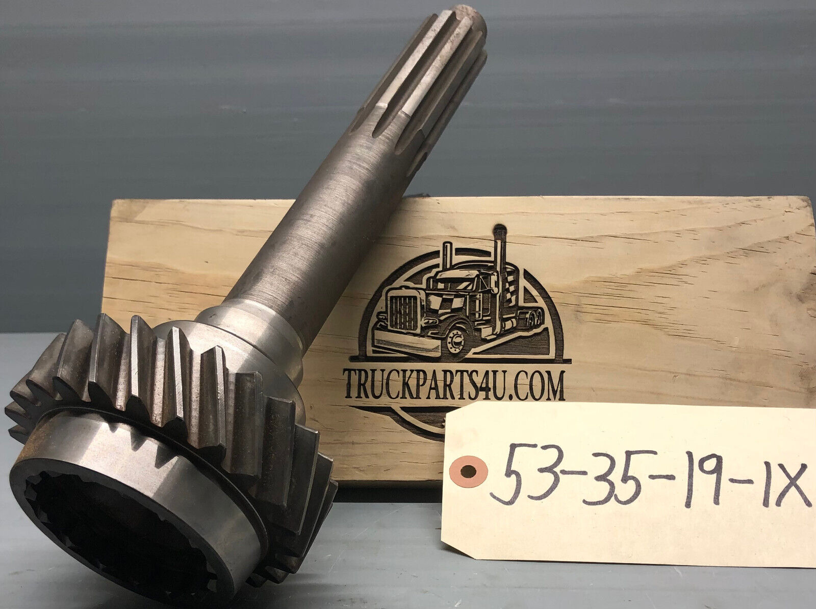 Dana Spicer / TTC input shaft 53-35-19-1X — CM5852 application, 1.500 inch 10-spline, OAL 13.078 in, front angled view with ID tag