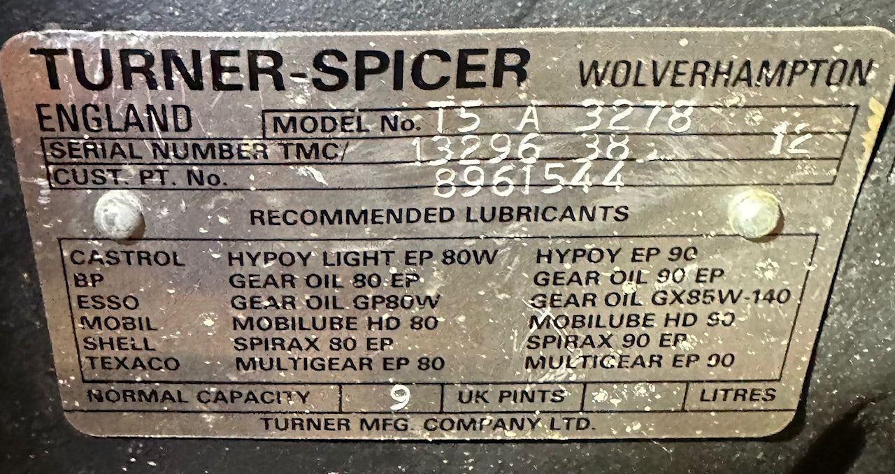 Close-up of factory Turner-Spicer Wolverhampton England data plate on NOS T5A-3278 (T5A-300 series) 5-speed overdrive transmission, showing model T5A-3278, serial TMC/13296 38 12, customer P/N 8961544, 9 UK pints capacity, and recommended EP lubricants