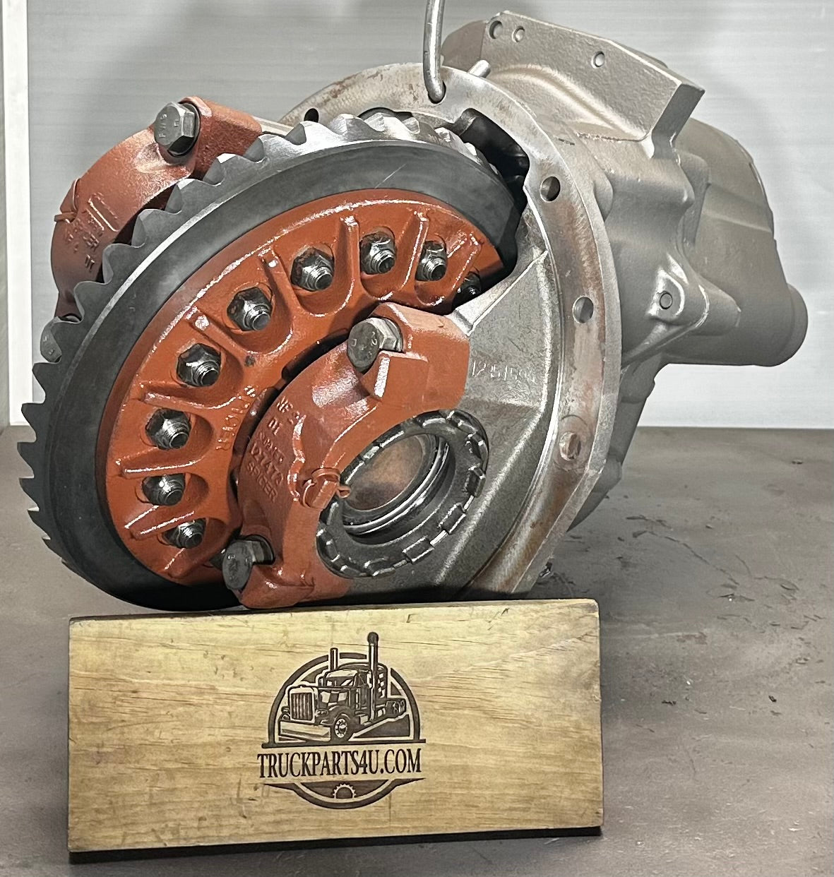 Top view of Dana Spicer DD404 differential showing large ring gear and carrier with orange paint protection