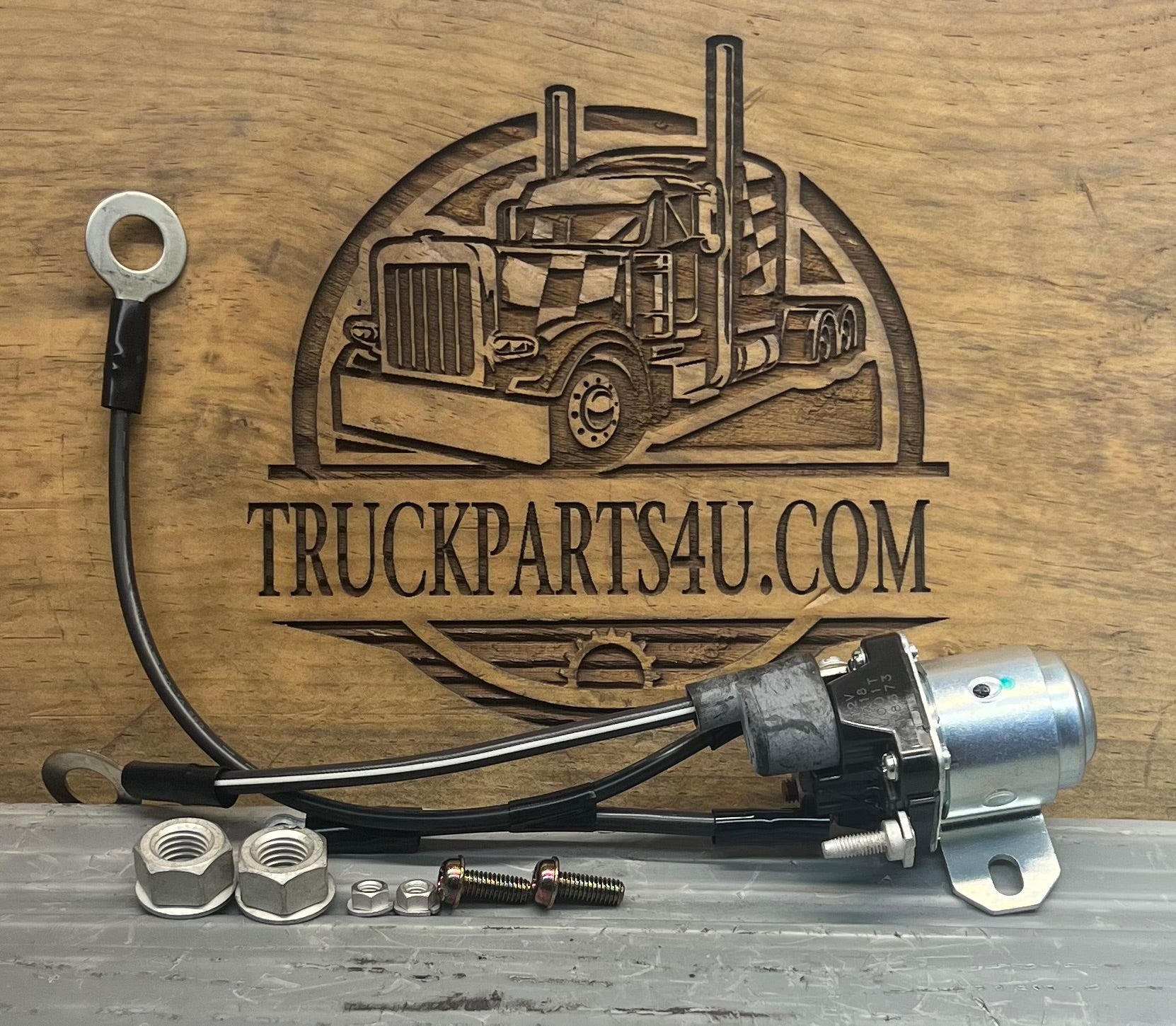 Full view of genuine Volvo Heavy Truck 85110714 12V starter relay and solenoid assembly with attached wiring leads, mounting bracket, nuts, and bolts