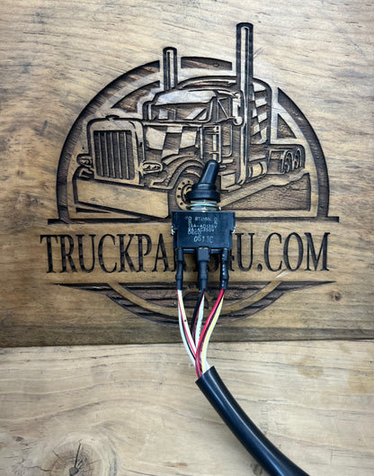 Front view of genuine Volvo CE 14526156 toggle switch assembly with rubber boot, wiring leads, and attached harness